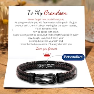 May include: A card with a message for a grandson, with the text "To My Grandson" and "Love you forever". The card also features a black leather bracelet with a silver infinity symbol and the text "Love you forever".