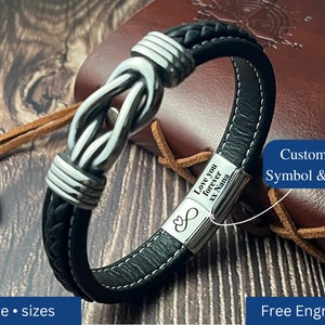May include: Black leather bracelet with a silver knot design and a silver plate engraved with the text "Love you forever XX Nana" and an infinity symbol. Customize the symbol and text with free engraving.