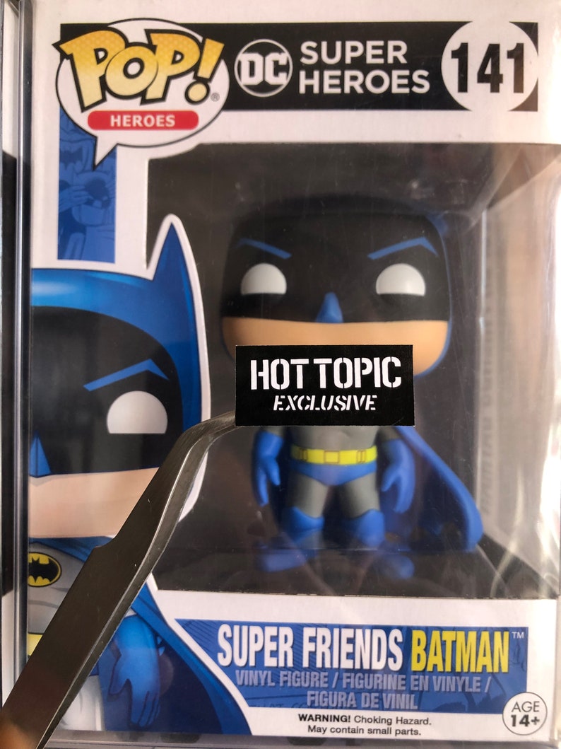 May include: A blue and black Batman Funko Pop! vinyl figure with a yellow belt and a white background. The figure is labeled "Super Friends Batman" and "Hot Topic Exclusive".