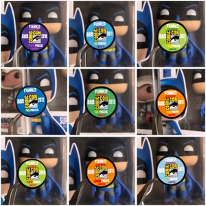 Puede incluir: Nueve figuras diferentes de Funko Pop! de Batman, cada una con una pegatina de color diferente en la parte delantera. Las pegatinas son todas redondas y tienen las palabras "Funko Exclusive Comic Con" en ellas. Las pegatinas también tienen el año de la convención y el número de piezas que se hicieron.