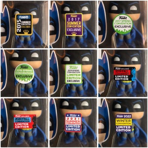 May include: A collection of nine Funko Pop figures of Batman, each with a different sticker indicating the year and type of convention they were released at. The stickers include "2015 Summer Convention Exclusive", "2017 Summer Convention Exclusive", "2018 Spring Convention Exclusive", "2019 Spring Convention Limited Edition Exclusive", "2019 Fall Convention Limited Edition", "2020 Fall Convention Limited Edition", "2021 Summer Convention Limited Edition", and "2022 Winter Convention Limited Edition".