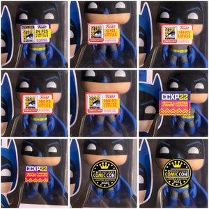 May include: Nine different versions of a Batman Funko Pop figure, each with a different convention sticker. The stickers are red, pink, and black with white text. The stickers say "Funko", "Limited Edition", "Comic Con", "CCXP22", and "Middle East Film & Comic Con".