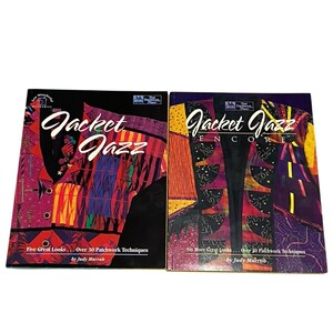 May include: Two books titled "Jacket Jazz" and "Jacket Jazz Encore" are displayed. The covers feature colorful patchwork jacket designs in shades of red, purple, orange, and yellow. The books are by Judy Murrah and showcase patchwork techniques.