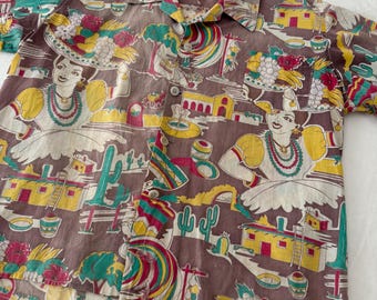 May include: A short-sleeved button-up shirt with a brown background and a colorful print. The print features figures, buildings, and cacti in yellow, red, green, and white. The shirt has a classic collar and a front pocket.