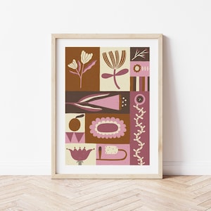 Pode incluir: Uma impressão emoldurada com um design geométrico que apresenta flores abstratas em tons de rosa, marrom e creme. A impressão é colocada contra uma parede branca.