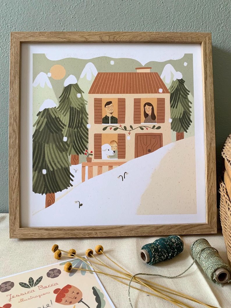May include: A framed illustration of a family of three standing in the windows of a house in a snowy landscape. The house is brown with white trim and a red roof. The family is wearing winter clothes and smiling. The illustration is set against a background of green trees and white snow.