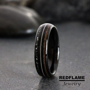 May include: Black tungsten carbide ring with a wood inlay and a row of black diamonds. The ring is a classic style with a modern twist.
