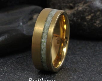May include: A gold-colored ring with a central band of light green stone. The ring has a brushed finish on the outer band and a polished interior. The word "Redflame" is written in cursive at the bottom of the image.