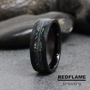 May include: Black tungsten carbide ring with a green and silver inlay. The ring has a hammered finish.