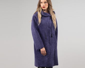 May include: A long, purple, fuzzy coat with a high collar and a drawstring at the waist.