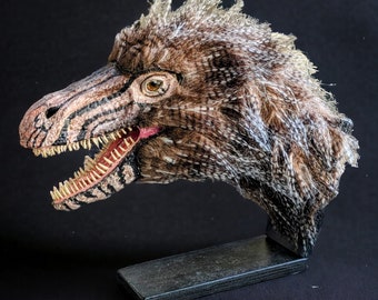 Realistic model of the head of a feathered raptor (dromaeosauridae) with wooden base. 3D printed, hand painted