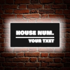 May include: Black rectangular sign with white text that reads "HOUSE NUM. YOUR TXET". The sign is illuminated with a white glow.