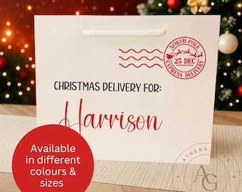 May include: A white gift bag with a red "North Pole Express Delivery" stamp and the text "Christmas Delivery For: Harrison." A red circle states "Available in different colours & sizes."