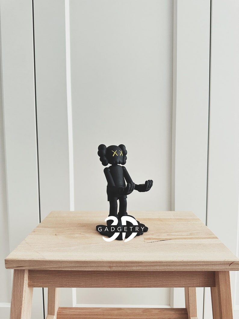 May include: Black and yellow figurine of a cartoon character with the text "3D GADGETRY" on the base.