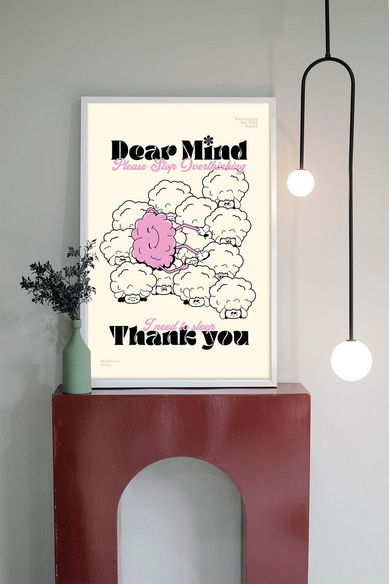 May include: Framed art print with the words "Dear Mind Please Stop Overthinking" and "I need to sleep Thank you." The illustration features a pink brain connected to sheep-like clouds. The print is displayed on a red shelf.