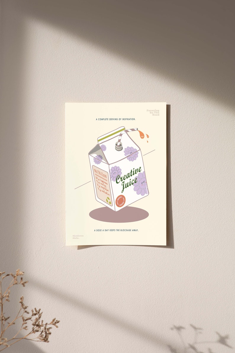 May include: A whimsical illustration of a carton of "Creative Juice" with purple flower accents. The carton features nutrition facts and the tagline "A dose a day keeps the blockage away." The artwork is on a cream-colored background.