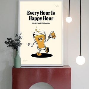 May include: A framed print with the text "Every Hour Is Happy Hour" and a cartoon beer character holding a mug. The print has a cream background and is displayed on a red shelf.