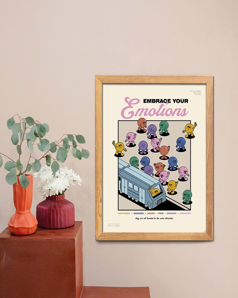 May include: A framed poster with the text "EMBRACE YOUR emotions" and illustrations of cartoon figures representing different emotions. The poster includes a bus and the words "Happiness, Sadness, Anger, Fear, Disgust, Surprise".