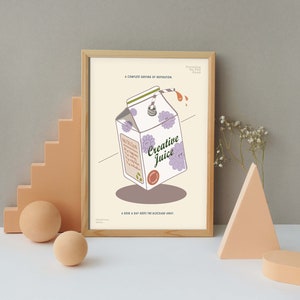May include: A framed art print featuring a whimsical illustration of a juice box labeled "Creative Juice." The juice box has purple flower accents and a straw. The print includes the text "A complete serving of inspiration" and "A dose a day keeps the blockage away."