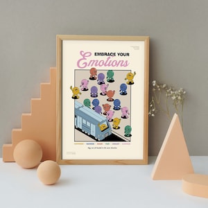 May include: A framed poster with the text "EMBRACE YOUR Emotions" and a cartoon illustration of various colored characters on a train. The poster includes the words "HAPPINESS, SADNESS, ANGER, FEAR, DISGUST, SURPRISE". The frame is a light brown color.