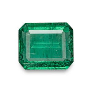 May include: A rectangular emerald-cut gemstone with a vibrant, deep green color. The stone features a faceted surface with visible internal inclusions and a clear, polished appearance, showcasing a classic step-cut design with sharp corners.