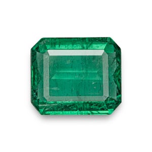 May include: A vibrant green emerald gemstone with a rectangular cut and a polished finish.