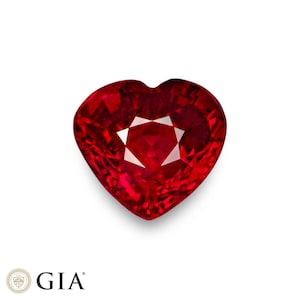 May include: A heart-shaped, faceted ruby gemstone. The ruby is a deep red colour with a brilliant, star-like facet pattern in the centre. The gemstone is set against a white background. The GIA logo is in the bottom left corner.