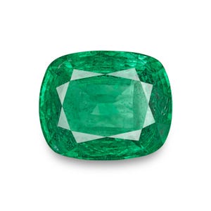 May include: A vibrant, cushion-cut emerald gemstone. The gem features a deep green hue with facets that reflect light. The shape is a rounded square, showcasing the stone's clarity and brilliance. The emerald is set against a white background.