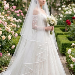 Full-length two-tier bridal veil extending behind the bride.