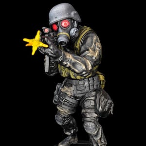 May include: A detailed figurine of a soldier wearing a grey helmet, a gas mask with glowing red lenses, and black tactical gear. The soldier holds a rifle with a yellow muzzle flash effect, standing on a black circular base with an umbrella logo.