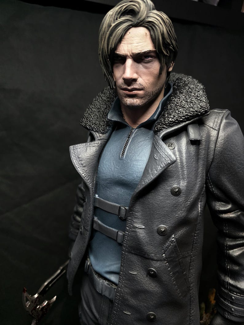 May include: A detailed figurine of a man with short, styled hair and a stern expression. He wears a dark gray leather coat with a fur collar over a blue shirt. The figure holds a weapon with a blood-like substance on it.