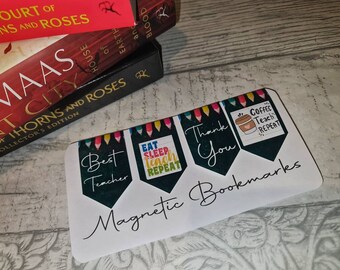 May include: Set of four magnetic bookmarks with colorful pencil designs. The bookmarks feature the text "Best Teacher", "Eat Sleep Teach Repeat", "Thank You", and "Coffee Teach Repeat".