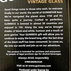 May include: Black background with the Guinness logo and text. The text reads "GUINNESS VINTAGE GLASS" and includes the establishment year "ESTD 1759". The text also includes a message about the brand.