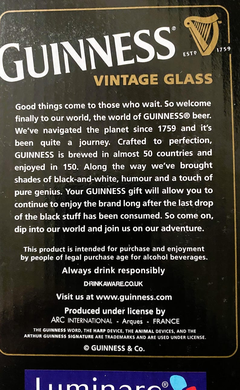 May include: Black background with the Guinness logo and text. The text reads "GUINNESS VINTAGE GLASS" and includes the establishment year "ESTD 1759". The text also includes a message about the brand.