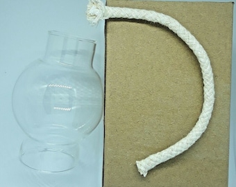 May include: A clear glass globe with a wide opening at the top and a smaller opening at the bottom. The globe is packaged in a brown cardboard box with a white cotton rope.