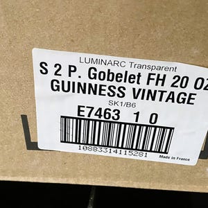 May include: A label on a cardboard box reads "LUMINARC Transparent S 2 P. Gobelet FH 20 OZ GUINNESS VINTAGE." The label also includes a barcode, the numbers "E7463 1 0," and "Made in France."