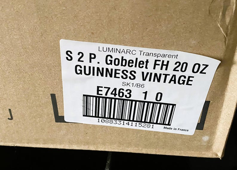 May include: A label on a cardboard box reads "LUMINARC Transparent S 2 P. Gobelet FH 20 OZ GUINNESS VINTAGE." The label also includes a barcode, the numbers "E7463 1 0," and "Made in France."