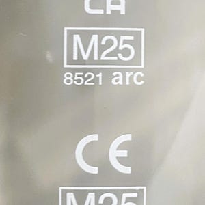May include: Close-up of a silver surface with the word "PINT" at the top, followed by "UK" and "CA". Below are the markings "M25" and "8521 arc". The CE mark and "M25" are at the bottom, with the number "0071".