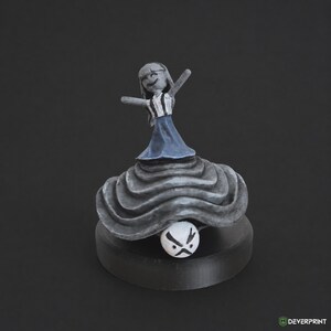 May include: A small, hand-painted figurine featuring a grey-skinned character with long hair, wearing a white top with black straps and a blue skirt. The character stands atop a large, layered grey mushroom-like base with a small white face at the bottom.