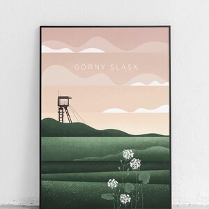 May include: Framed art print featuring a landscape scene. The artwork depicts a green field with a watchtower and white flowers. The sky is a gradient of pink and peach with the text "GÓRNY ŚLĄSK".
