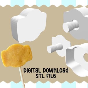 May include: An image shows a cookie on a stick next to 3D models of a cookie cutter. The cookie is golden brown. The cookie cutter models are white. The text "DIGITAL DOWNLOAD STL FILE" is at the bottom.
