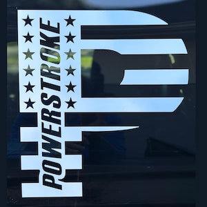 May include: White vinyl decal with the text "POWERSTROKE" and a stylized American flag design. The flag is in the shape of the letter "P".