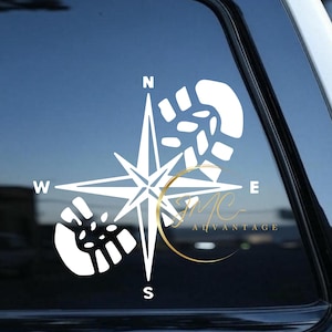 May include: White vinyl decal of a compass with footprints on the north, south, east, and west points. The compass points are labeled with the letters N, S, E, and W.