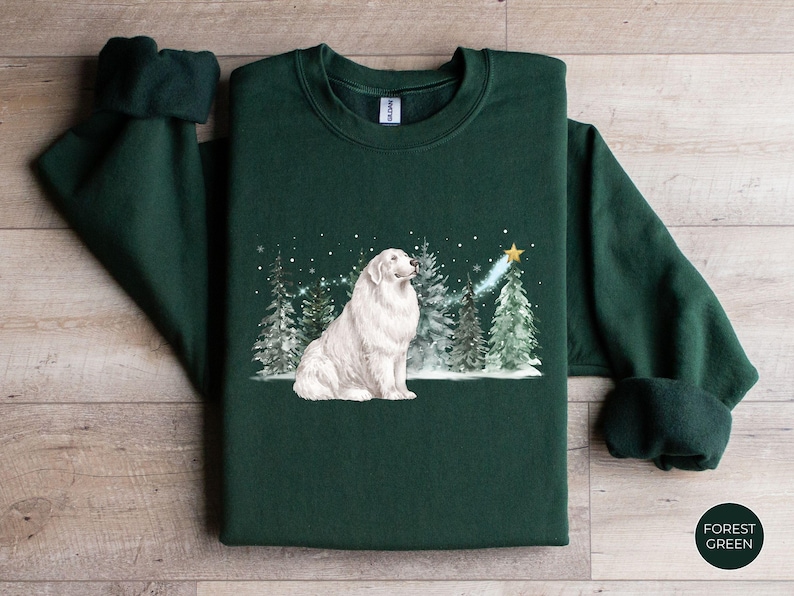 May include: Forest green sweatshirt featuring a white dog illustration in a winter scene with snow and Christmas trees. A shooting star and the text "Forest Green" are also visible.