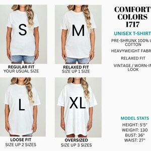 May include: A white Comfort Colors 1717 unisex t-shirt shown in sizes S, M, L, and XL. The text specifies pre-shrunk 100% US cotton, heavyweight fabric, and fit descriptions ranging from regular to oversized. Model stats are listed as 5'5" height.