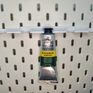 May include: A silver tube of Winsor & Newton Galeria Acrylic paint in Hooker's Green. The tube is 60 ml or 2.0 US fl oz.