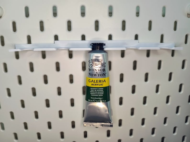 May include: A silver tube of Winsor & Newton Galeria Acrylic paint in Hooker's Green. The tube is 60 ml or 2.0 US fl oz.
