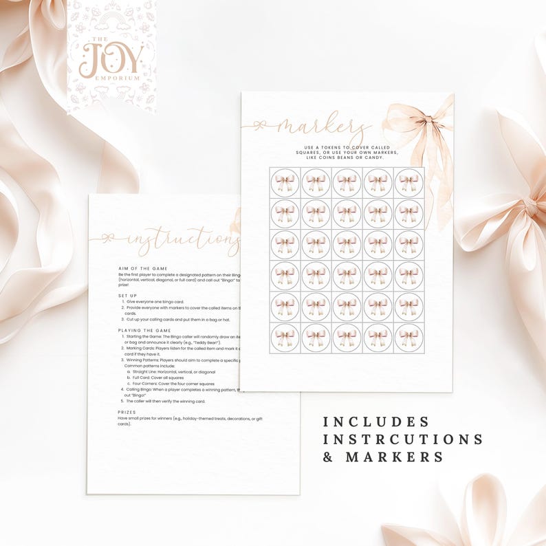 May include: A printable bingo game with instructions and markers. The game features a pink and white bow design with the words "The Joy Emporium" and "Markers" in gold lettering.