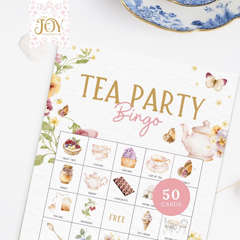 May include: A white card with a gold title "Tea Party Bingo" and a grid of 25 squares. Each square contains a watercolor illustration of a tea party item, such as a teapot, teacups, cupcakes, and fruit tarts. The card also includes the text "50 Cards".