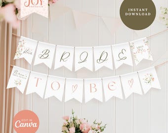 May include: A white bridal shower banner with pink floral accents. The banner reads "Bride to Be" with a heart symbol between the words "to" and "be".